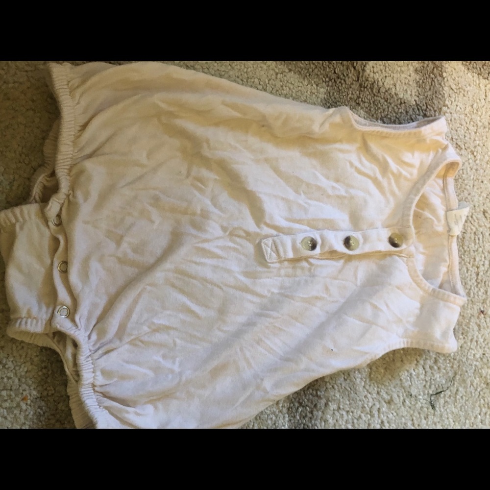 Cream three buttoned body-suit.